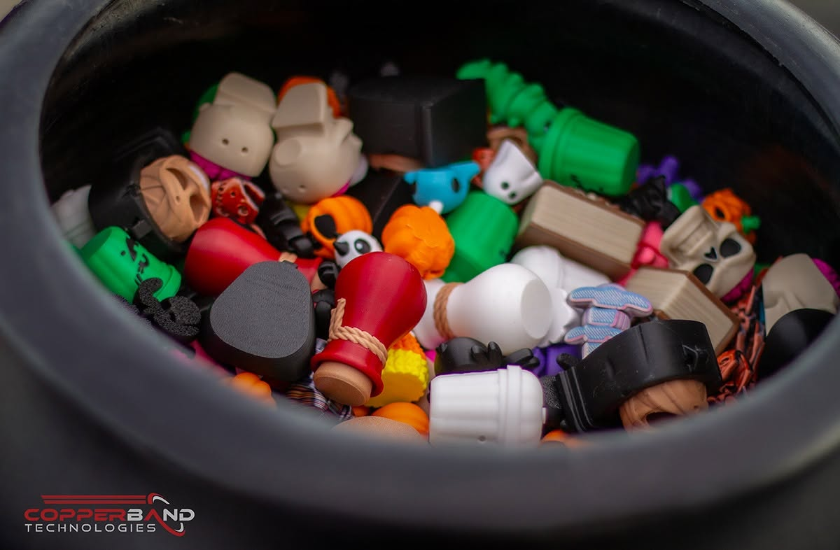 A cauldron filled with colorful 3D printed fidget toys handed out at Fright on Franklin