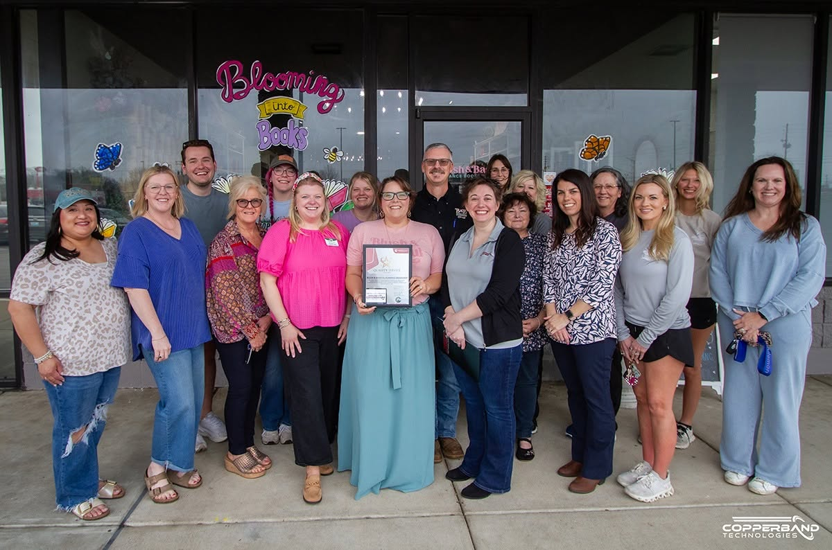 Chamber members outside Blush and Bashful Romance Bookshop at the March 2026 Quality Service Award presentation