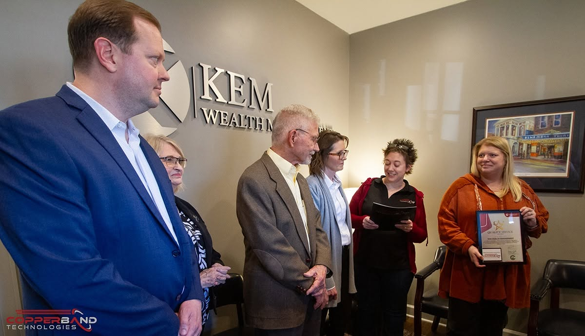 The February 2026 Quality Service Award being presented at the Kem Wealth Management office