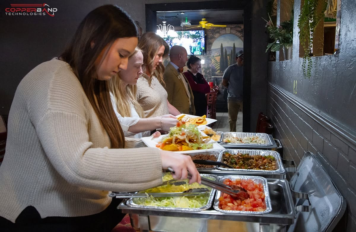 Guests serving themselves from the buffet at the April 2026 Quality Service Award presentation