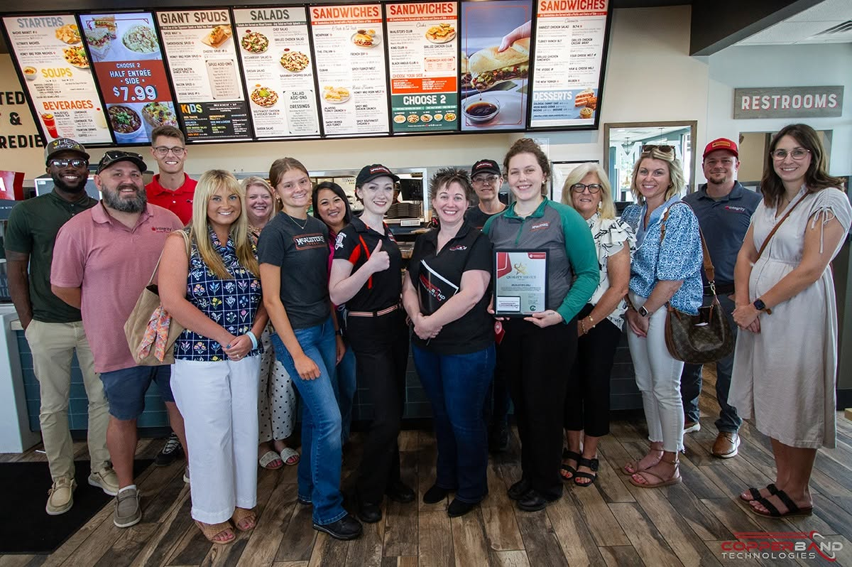 Chamber members and community supporters at the July 2026 Quality Service Award presentation at McAlister's Deli