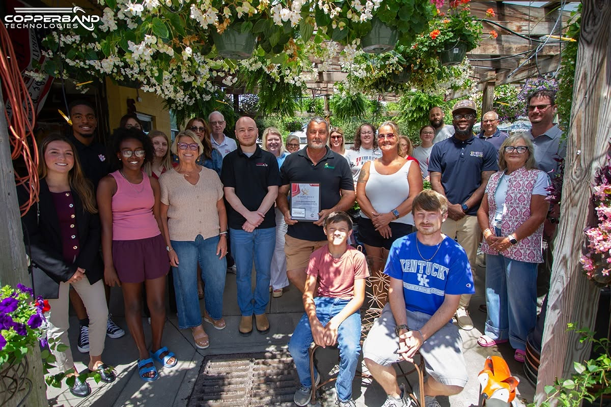 Chamber members and the Superlawn and Garden team under the greenhouse at the June 2026 Quality Service Award presentation