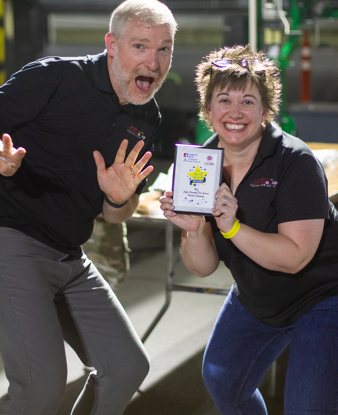Two Copperband team members celebrating with the 2026 Best of Clarksville plaque for Best Cyber Security/Tech Service Provider Company